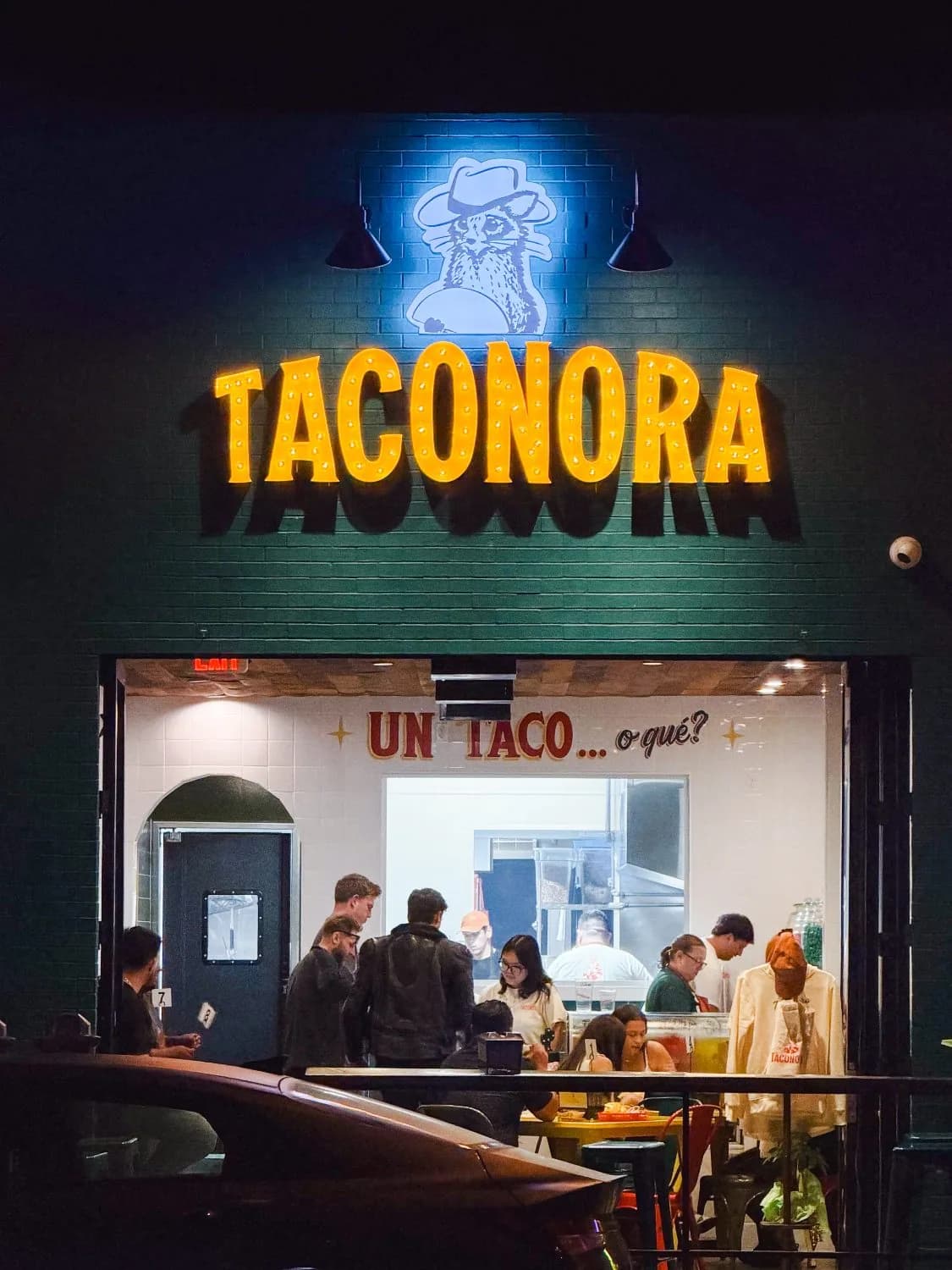 Taconora storefront at night