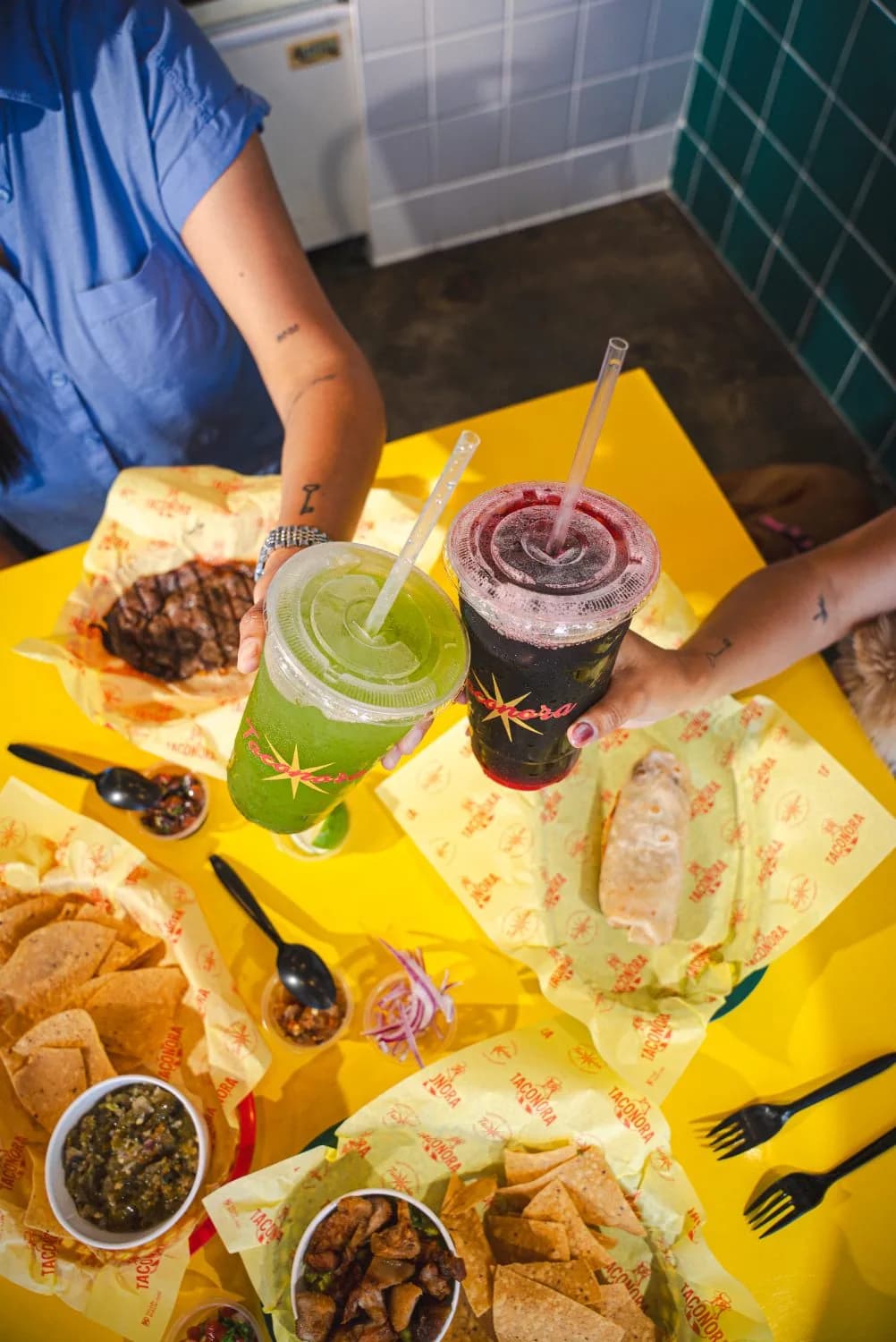 Table served with tacos and aguas frescas